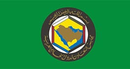 UAE flag with green background and emblem in the center.