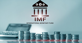 Intderntiona Monetary Fund logo and stacks of coins