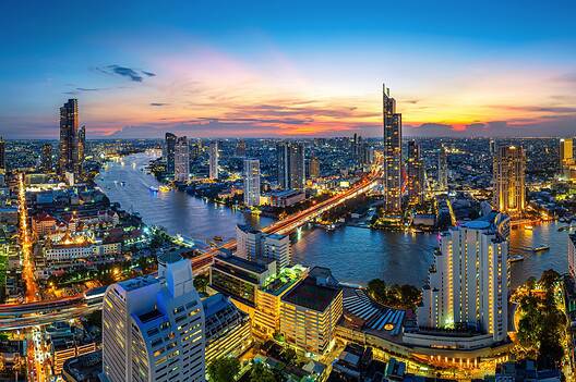 Panorama of the Bangkok skyline at twilight, where the IMF and World Bank annual meeting is being held.