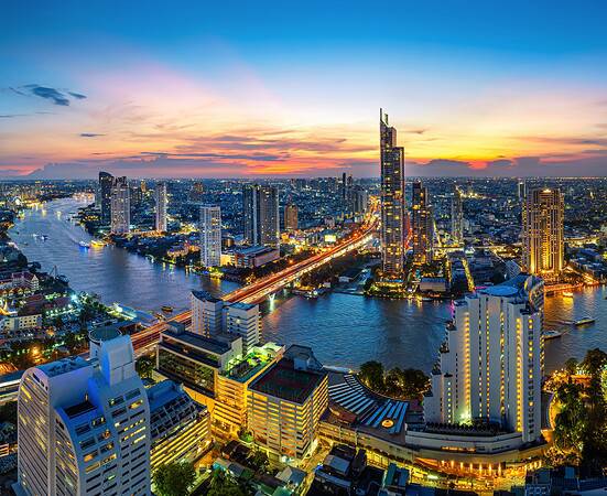 Panorama of the Bangkok skyline at twilight, where the IMF and World Bank annual meeting is being held.