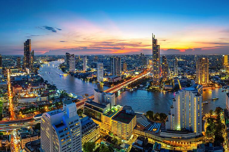 Panorama of the Bangkok skyline at twilight, where the IMF and World Bank annual meeting is being held.