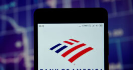 Bank of America logo is seen on an smartphone over stock chart. Bank of America logo is displayed on the screen of a mobile device.