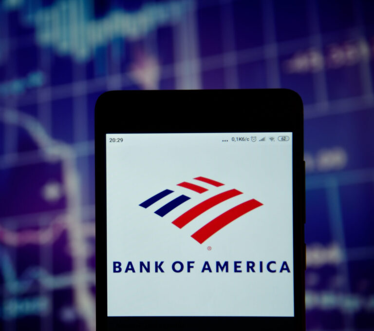 Bank of America logo is seen on an smartphone over stock chart. Bank of America logo is displayed on the screen of a mobile device.