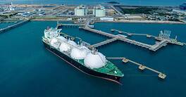 LNG (Liquified Natural Gas) tanker anchored in Gas terminal gas tanks for storage. Oil Crude Gas Tanker Ship. LPG at Tanker Bay Petroleum Chemical or Methane freighter export import transportation.