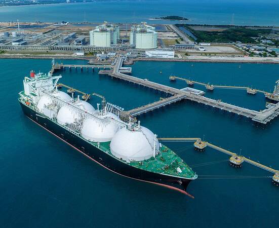 LNG (Liquified Natural Gas) tanker anchored in Gas terminal gas tanks for storage. Oil Crude Gas Tanker Ship. LPG at Tanker Bay Petroleum Chemical or Methane freighter export import transportation.