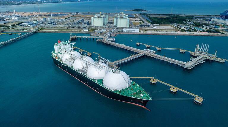 LNG (Liquified Natural Gas) tanker anchored in Gas terminal gas tanks for storage. Oil Crude Gas Tanker Ship. LPG at Tanker Bay Petroleum Chemical or Methane freighter export import transportation.