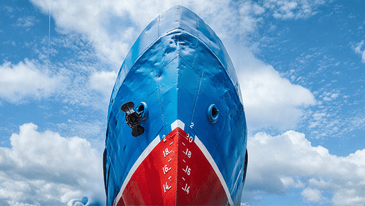 A big blue ship is under repair