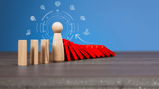 Wooden figure stops falling red domino blocks symbolizing risk management, crisis prevention, and strategic decision-making. Abstract icons represent legal, global, and business responsibility