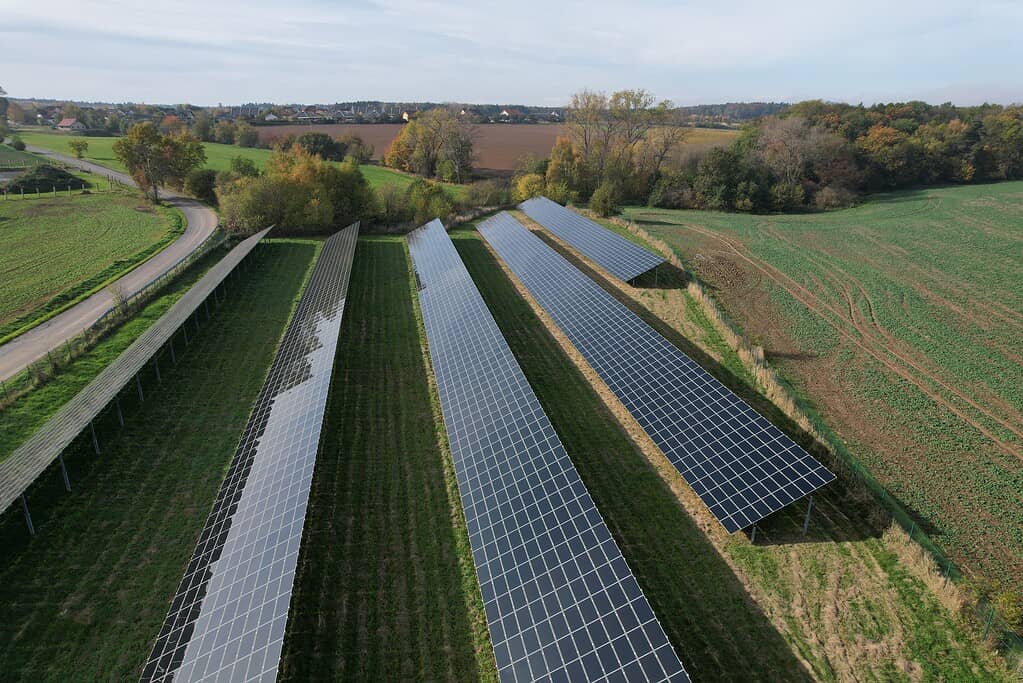 Modern solar power plant, photovoltaic panels green energy electricity production,new power plant,European energy crisis 2022, green deal,Czech republic,European Union,aerial panorama from foggy cloud
