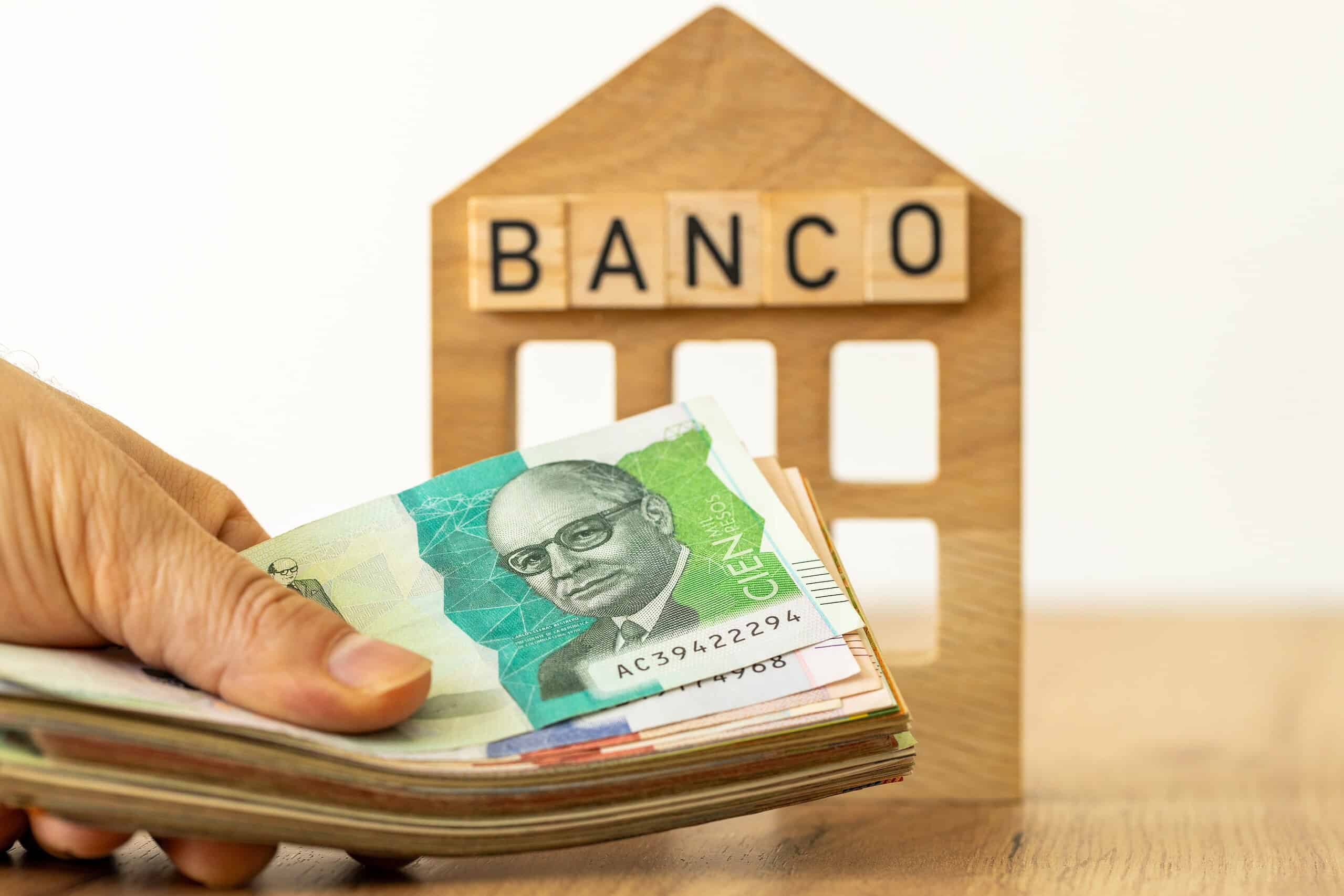 Bank loan in Colombian peso. Financial business concept. Bank symbol, handing cash to customer. Money transfer, Financial operations in Colombia currency. close up