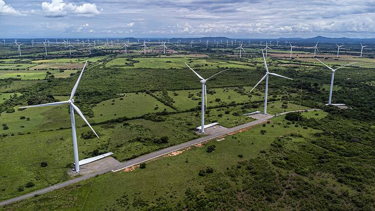 Aerial drone photo of a wind turbines captured in Penonome, Panama. Large wind farm on a sunny day. Clean energy, renewable power, and sustainable development in Latin America.