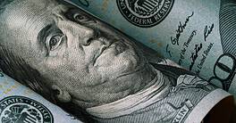 Closeup of Benjamin Franklin face on USD dollar banknote for dollar is the main of currency exchange in the world.