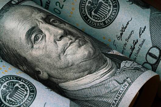 Closeup of Benjamin Franklin face on USD dollar banknote for dollar is the main of currency exchange in the world.