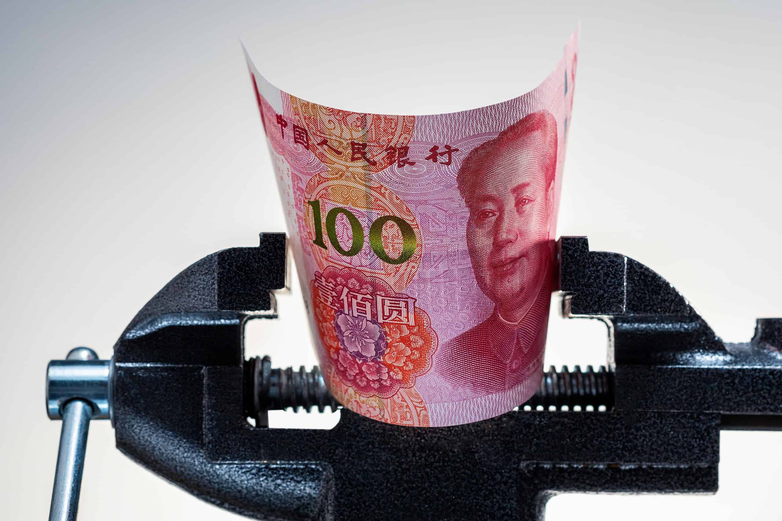 Chinese economy crisis. Pressing on yuan banknote. Inflation, restrictions in China. Yuan money under pressure.