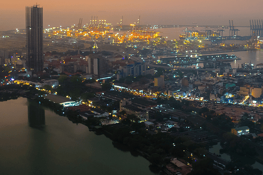 Modern Skyline of Colombo at Night with Glowing Lights and Ocean View