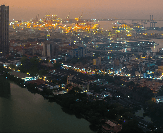 Modern Skyline of Colombo at Night with Glowing Lights and Ocean View