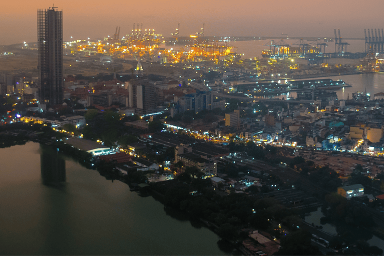 Modern Skyline of Colombo at Night with Glowing Lights and Ocean View