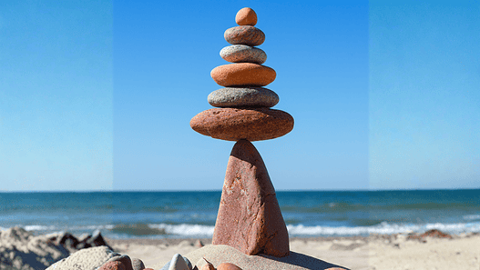 Rock zen pyramid balanced on a cliff edge on the beach. Concept of Life balance, harmony and meditation