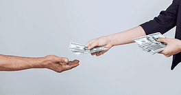 two arms stretched out handing cash to one hand