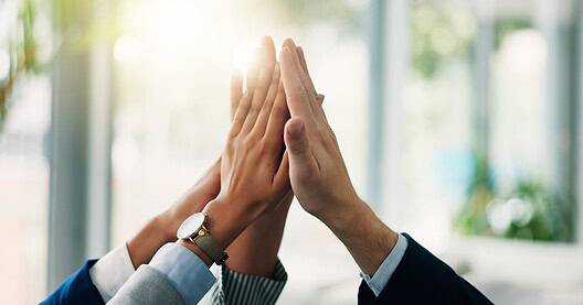 Business people's hands high-fiving
