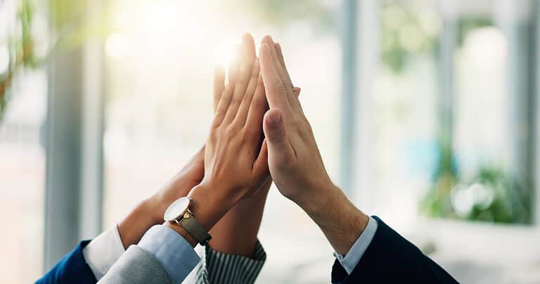 Business people's hands high-fiving