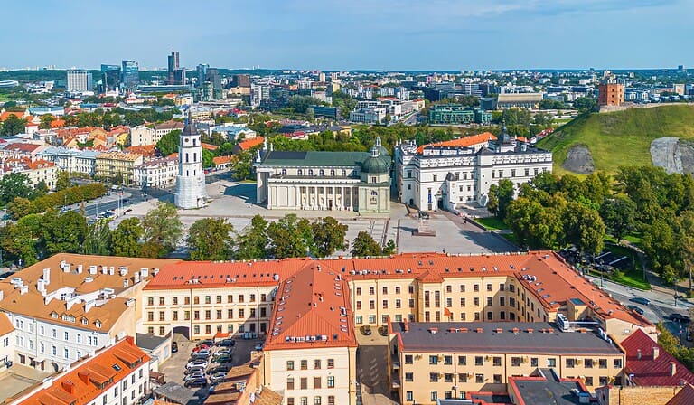 A panoramic view of Vilnius, Lithuania, showcasing historic architecture and modern city skyline.