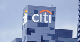 Citi logo on a modern office skyscraper in an urban setting.