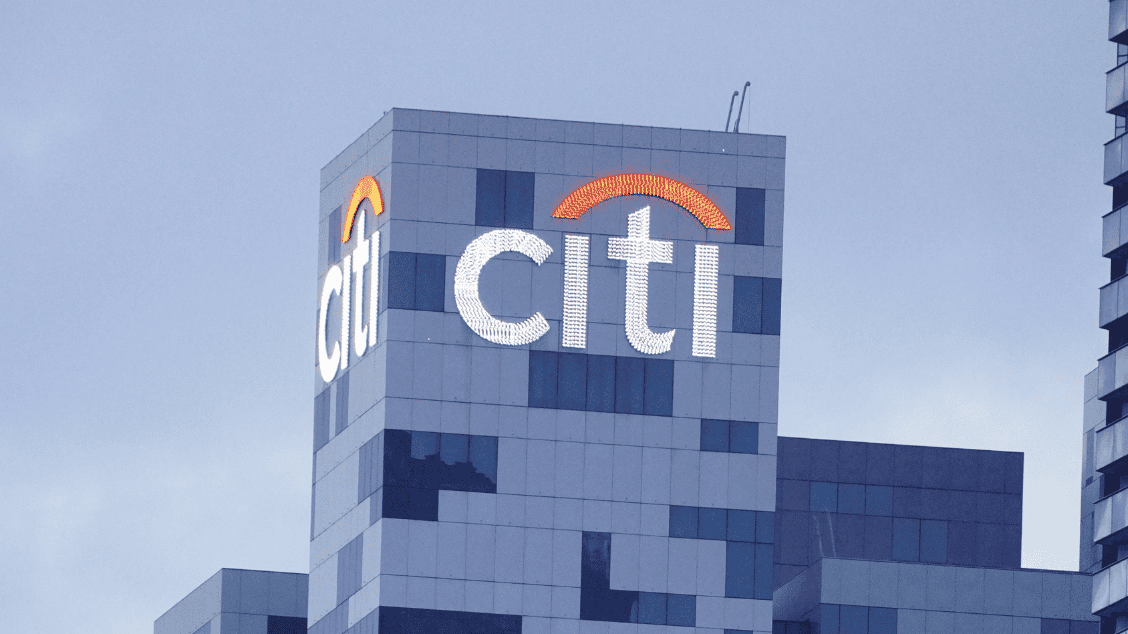 Citi logo on a modern office skyscraper in an urban setting.