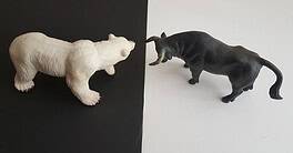 Animal figurines representing competition or conflict in a financial context.
