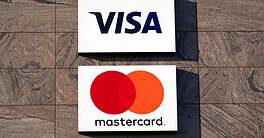 Logos of Visa and Mastercard credit card companies at stone facade of office building at Zürich Glattbrugg on a sunny winter day. Photo taken January 13th, 2022, Zurich, Switzerland.