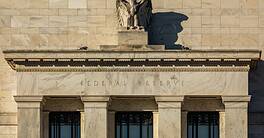 Federal Reserve building with eagle sculpture and stone facade.