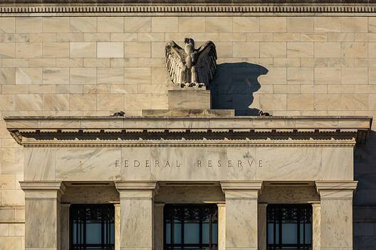 Federal Reserve building with eagle sculpture and stone facade.