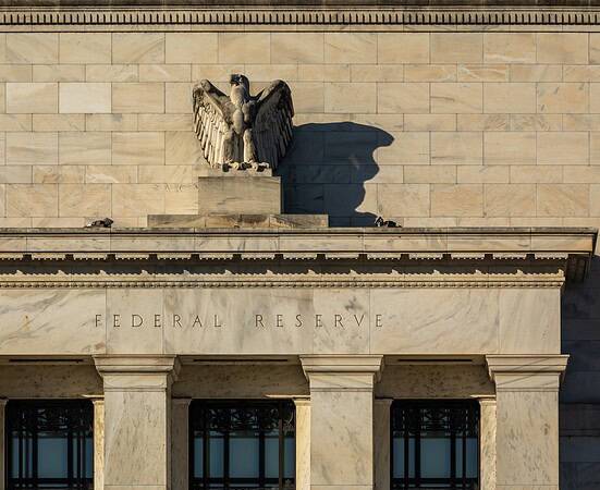 Federal Reserve building with eagle sculpture and stone facade.