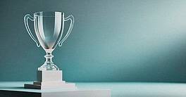 Trophy award symbolizing financial success and achievement, set against a minimalist background.