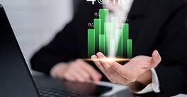 Business professional analyzing financial growth data on smartphone with digital charts.
