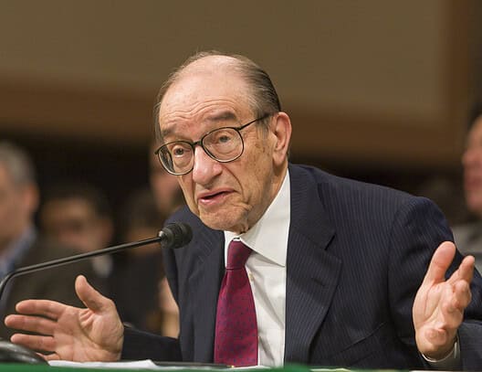 Alan Greenspan speaking at a congressional hearing about economic policy.