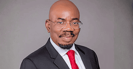 Jim Ovia in formal suit and glasses.