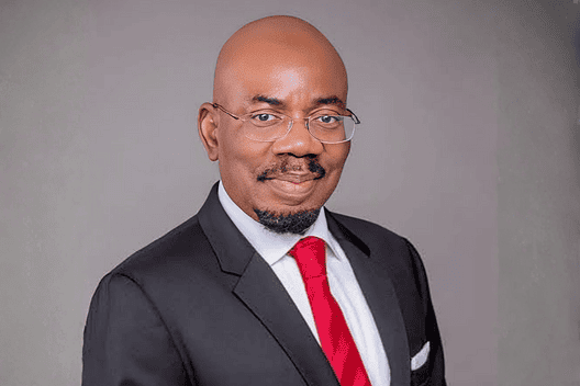 Jim Ovia in formal suit and glasses.