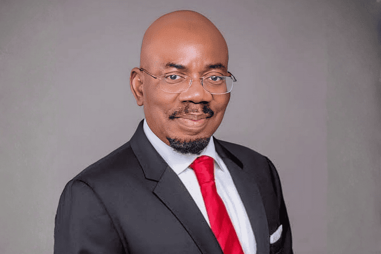 Jim Ovia in formal suit and glasses.