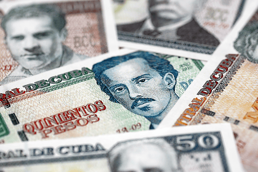 Cuban peso money bills pile on table. Cuba banknotes of CUP currency close up. Concept of business, economy and banking in Cuba