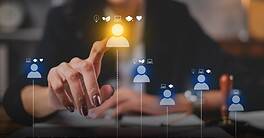 Businesswoman interacting with digital workforce icons on a touchscreen.