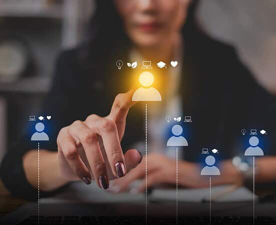 Businesswoman interacting with digital workforce icons on a touchscreen.