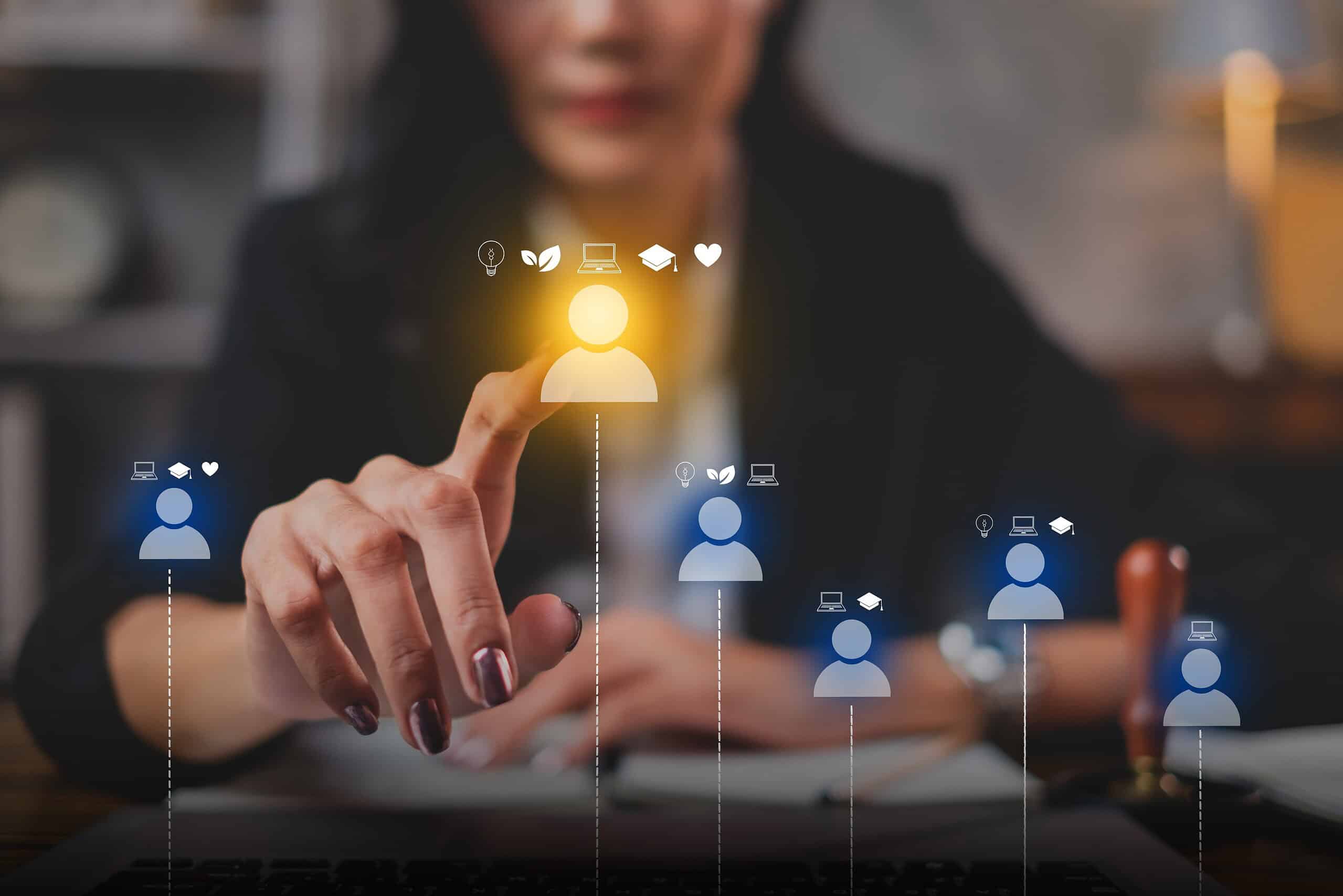 Businesswoman interacting with digital workforce icons on a touchscreen.