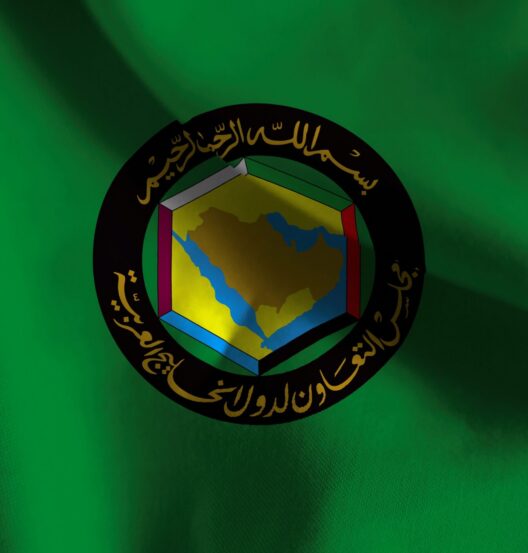 GCC flag featuring emblem and green background.