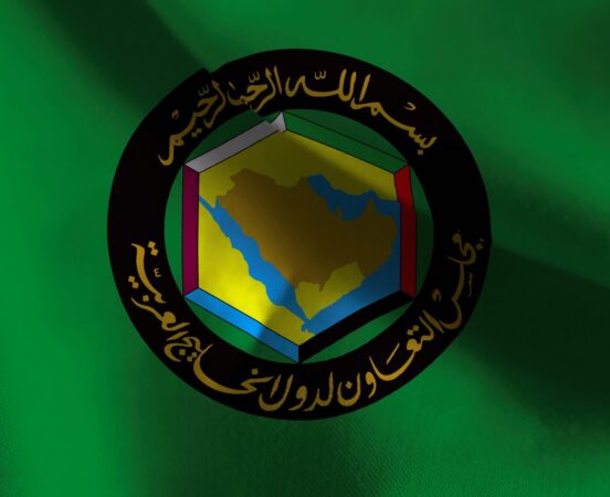 GCC flag featuring emblem and green background.