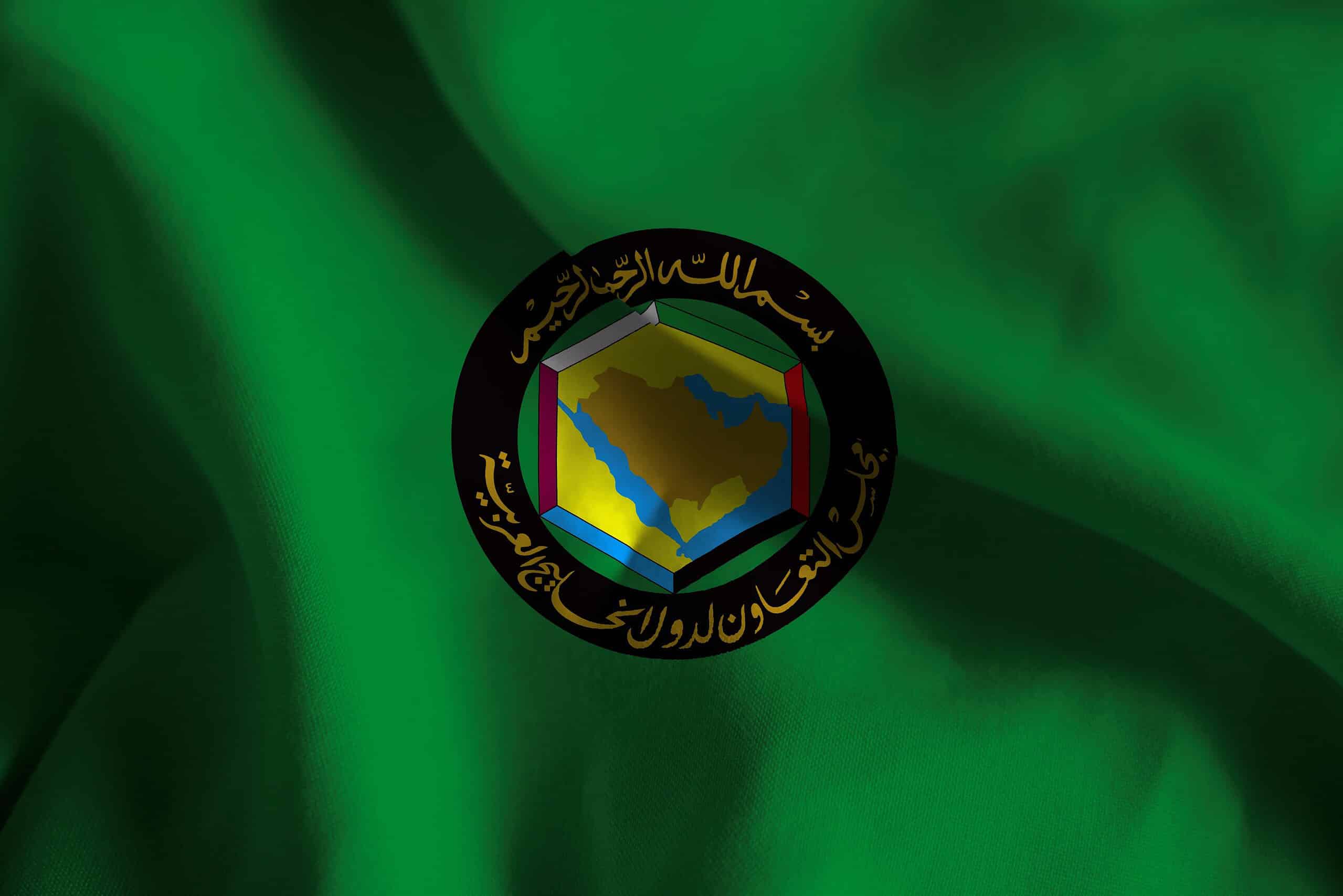 GCC flag featuring emblem and green background.