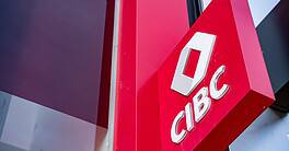CIBC bank logo on building exterior in urban setting.