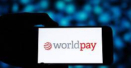 Worldpay logo displayed on a smartphone screen in a dark setting.