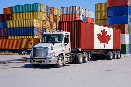 A Canada-marked shipping container on a truck, illustrating Canadian international trade - Montage