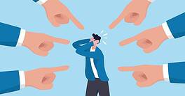 Person overwhelmed by multiple pointing fingers in workplace.